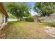 Spacious backyard with a mix of grass, trees, and fencing at 1330 Broken Pine Rd, Deltona, FL 32725