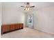 Cozy bedroom with a wooden dresser, neutral carpet, and a window at 1330 Broken Pine Rd, Deltona, FL 32725