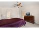 Cozy bedroom with ceiling fan, dresser, and access to the bathroom and kitchen at 1330 Broken Pine Rd, Deltona, FL 32725