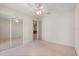 Bedroom featuring a mirrored closet, neutral walls and carpet, and a ceiling fan at 1330 Broken Pine Rd, Deltona, FL 32725