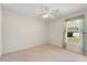 Bright bedroom featuring neutral carpet, ceiling fan, and natural light from the window at 1330 Broken Pine Rd, Deltona, FL 32725
