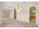 Open-concept dining area with chandeliers and access to the kitchen, ideal for entertaining at 1330 Broken Pine Rd, Deltona, FL 32725