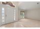 Welcoming foyer featuring tile flooring, natural light, and an arched transom window above the front door at 1330 Broken Pine Rd, Deltona, FL 32725