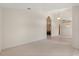 Spacious carpeted living room with elegant archways, ready for personalization at 1330 Broken Pine Rd, Deltona, FL 32725