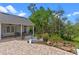 Spacious backyard patio, adjacent to a beautifully landscaped garden, perfect for outdoor living at 1417 Olympia Ave, Mount Dora, FL 32757