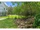 Lush backyard landscaping features a tranquil rock waterfall and green lawn at 1417 Olympia Ave, Mount Dora, FL 32757