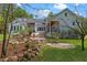 Backyard featuring a stone garden, water feature, and a charming home exterior at 1417 Olympia Ave, Mount Dora, FL 32757