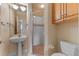 Bathroom with a pedestal sink and a glass-enclosed shower at 1417 Olympia Ave, Mount Dora, FL 32757