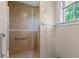 Bathroom featuring glass shower with grab bar and tile surround at 1417 Olympia Ave, Mount Dora, FL 32757