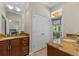 Bathroom featuring double granite vanity, closet and access to outdoor balcony at 1417 Olympia Ave, Mount Dora, FL 32757