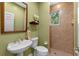Charming bathroom with walk-in shower, pedestal sink, and green walls at 1417 Olympia Ave, Mount Dora, FL 32757