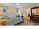 Bedroom with wood floors, two windows and a bed with a floral patterned rug at 1417 Olympia Ave, Mount Dora, FL 32757