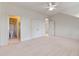 Spacious bedroom with neutral carpet and multiple doorways at 1417 Olympia Ave, Mount Dora, FL 32757