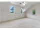 Bright bedroom featuring neutral carpet and three windows at 1417 Olympia Ave, Mount Dora, FL 32757