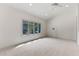 Large bonus room with vaulted ceiling and large window overlooking backyard at 1417 Olympia Ave, Mount Dora, FL 32757