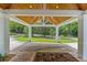 View of home's carport featuring stained wood ceiling and manicured landscaping at 1417 Olympia Ave, Mount Dora, FL 32757