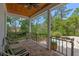 Relaxing covered patio with comfortable seating and a view of the lush backyard at 1417 Olympia Ave, Mount Dora, FL 32757