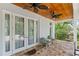 Relaxing covered patio with brick flooring, ceiling fans, and views of the beautifully landscaped yard at 1417 Olympia Ave, Mount Dora, FL 32757