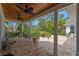Inviting covered patio featuring ceiling fans, brick flooring, and a picturesque view of the backyard at 1417 Olympia Ave, Mount Dora, FL 32757