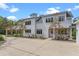 Elegant home featuring a long driveway, flowering plants, and a well-manicured yard at 1417 Olympia Ave, Mount Dora, FL 32757