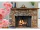 Inviting stone fireplace with a wooden mantel, perfect for cozy evenings at 1417 Olympia Ave, Mount Dora, FL 32757
