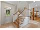 Bright foyer with hardwood stairs, tile flooring, and glass panel door at 1417 Olympia Ave, Mount Dora, FL 32757