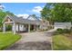 Exterior elevation featuring a porte cochere and a long driveway leading to a detached garage at 1417 Olympia Ave, Mount Dora, FL 32757