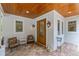 Covered front porch featuring an amber-colored door, brick flooring, and decor at 1417 Olympia Ave, Mount Dora, FL 32757