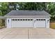 A three-car garage with white doors and exterior sconce lighting at 1417 Olympia Ave, Mount Dora, FL 32757