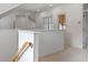 Bright hallway with carpet, white walls, railing, and windows at 1417 Olympia Ave, Mount Dora, FL 32757