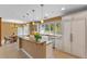 Spacious kitchen featuring granite counters, a central island, and adjacent breakfast nook at 1417 Olympia Ave, Mount Dora, FL 32757