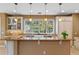 Kitchen with granite countertop and view of backyard through ample windows at 1417 Olympia Ave, Mount Dora, FL 32757