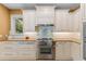 Kitchen with stainless steel appliances, custom backsplash, and granite countertops at 1417 Olympia Ave, Mount Dora, FL 32757