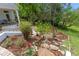 Well-manicured landscaping featuring a variety of plants, rocks, and a stone path at 1417 Olympia Ave, Mount Dora, FL 32757