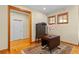 Cozy living room with wood floors, area rug, wooden trim and windows at 1417 Olympia Ave, Mount Dora, FL 32757