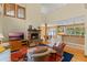 Spacious living room with a stone fireplace, large windows, and an open layout at 1417 Olympia Ave, Mount Dora, FL 32757