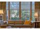 Living room with large windows, patterned drapes, lamps and a cozy couch at 1417 Olympia Ave, Mount Dora, FL 32757