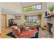 Inviting living room featuring a stone fireplace, hardwood floors, and soaring ceilings at 1417 Olympia Ave, Mount Dora, FL 32757