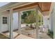 Covered porch view of the garage, driveway, and a garden at 1417 Olympia Ave, Mount Dora, FL 32757
