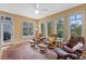 Bright sunroom with multiple chairs and scenic views at 1417 Olympia Ave, Mount Dora, FL 32757