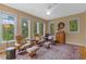 Bright sitting room features multiple windows and comfortable leather seating at 1417 Olympia Ave, Mount Dora, FL 32757