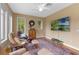 Cozy sitting room with large windows and ceiling fan at 1417 Olympia Ave, Mount Dora, FL 32757