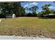 Large backyard with mature trees and a storage shed at 1433 Kingston Ave, Orlando, FL 32807