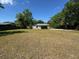 Extensive backyard featuring a mix of grass, trees and a shed at 1433 Kingston Ave, Orlando, FL 32807