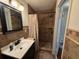 A bathroom featuring a vanity with shower stall at 1433 Kingston Ave, Orlando, FL 32807