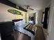 Bedroom featuring bed with patterned blanket, closet, surf board, and ceiling fan at 1433 Kingston Ave, Orlando, FL 32807