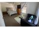 Bedroom with a large bed, side windows, sofa, and coffee table at 1433 Kingston Ave, Orlando, FL 32807