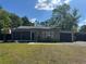 Charming single-story home with a well-maintained lawn and mature trees at 1433 Kingston Ave, Orlando, FL 32807