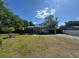 Charming single-story home with a well-maintained lawn and mature trees at 1433 Kingston Ave, Orlando, FL 32807