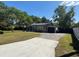 Quaint single-story home with a paved driveway and manicured lawn at 1433 Kingston Ave, Orlando, FL 32807